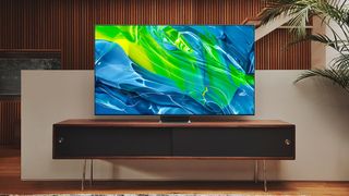 The Samsung S95B OLED TV on a TV stand.