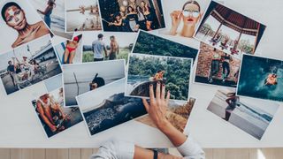 Someone laying their photos on a table.